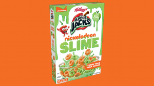 On a bright orange background is a box of Apple Jacks x Nickelodeon Slime cereal. The box notes that the cereal turns your milk green and is green apple flavored.
